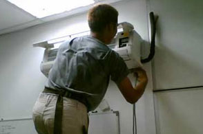Another Man installing wall mounted air conditioning